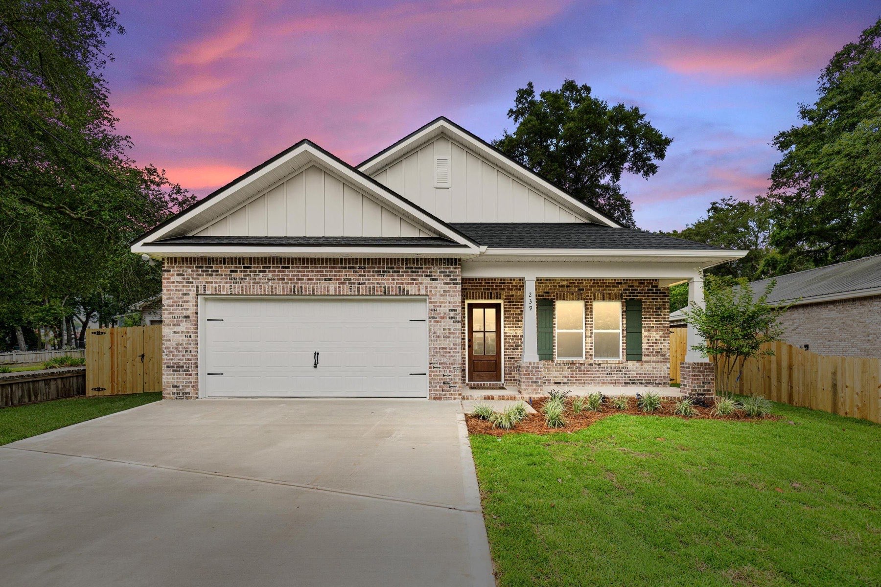 A Grand American Homes brick home at dusk